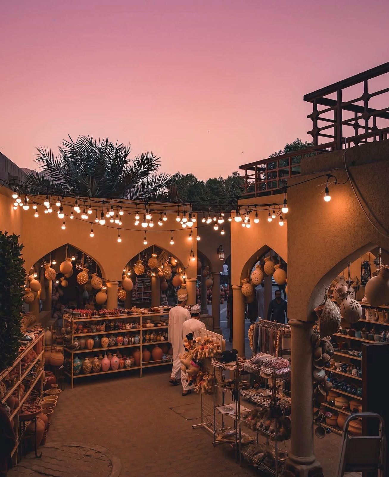 Nizwa souq at dusk, lined with pottery and warm lights